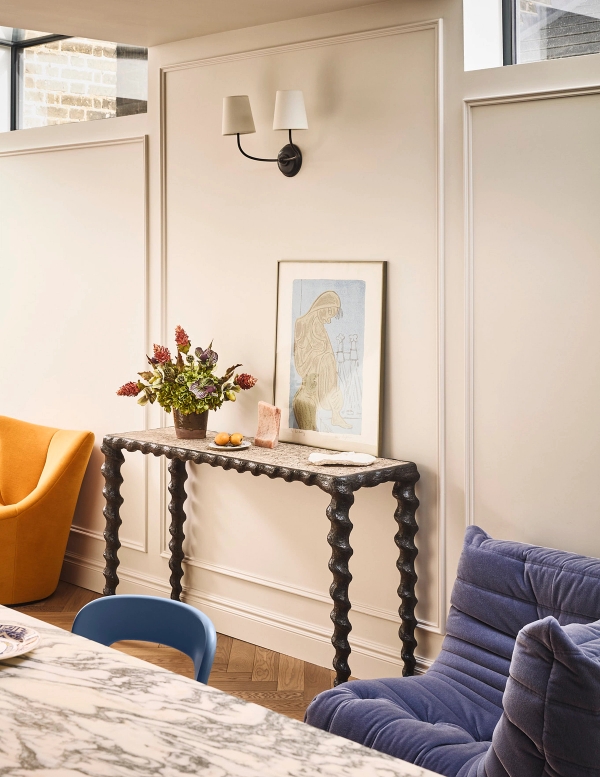 Elegantly styled hallway console table set against light pink wall panelling with framed art, Love Locations SE21.