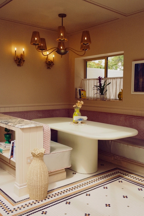Bespoke kitchen island setup featuring pink mosaic trim and fresh yellow flowers, excellent for boutique homeware and editorial food photography, Love Locations.