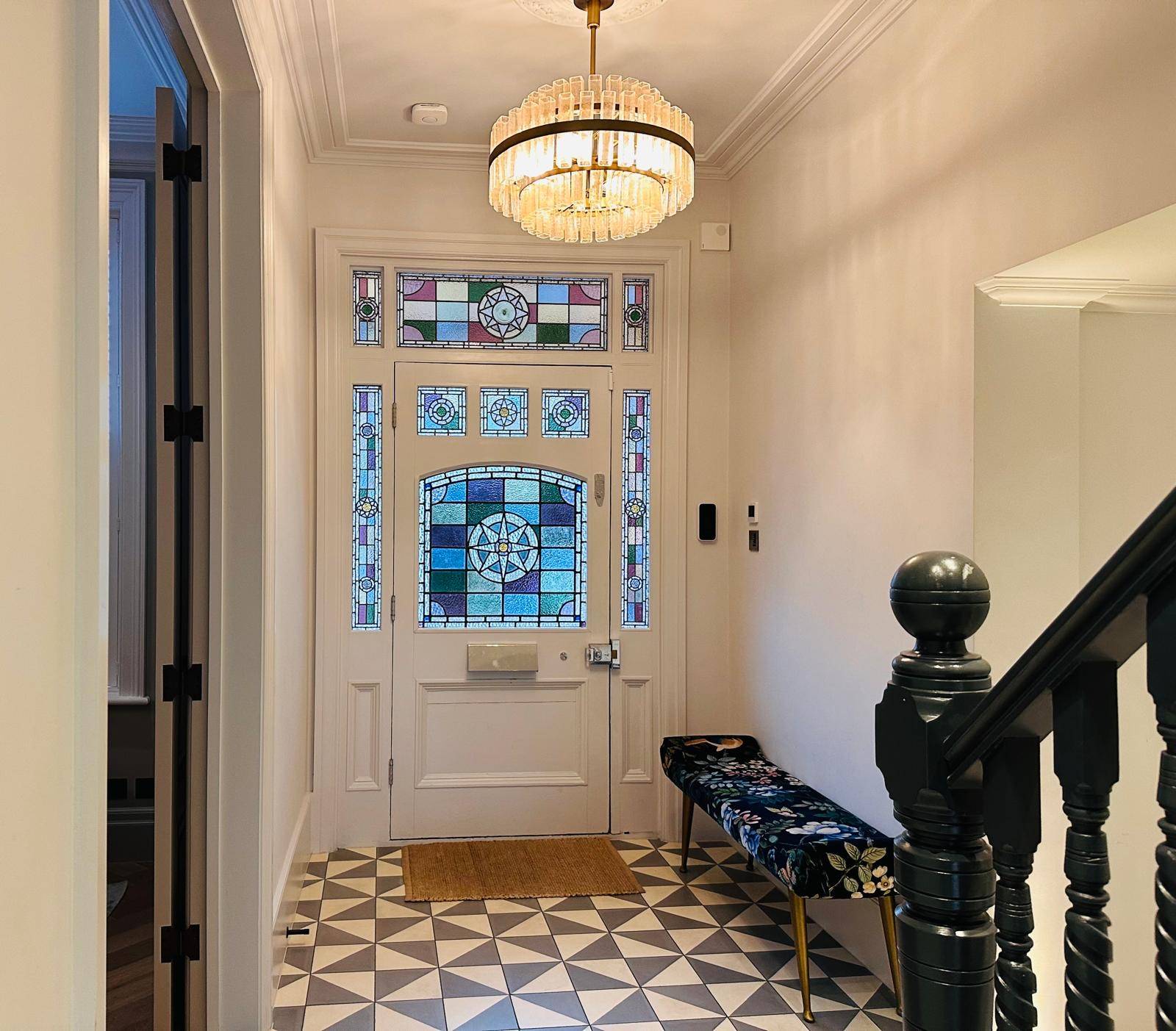 Victorian hallway entrance with stained glass front door, decorative ceiling rose, and geometric floor tiles, Love Locations TW11.