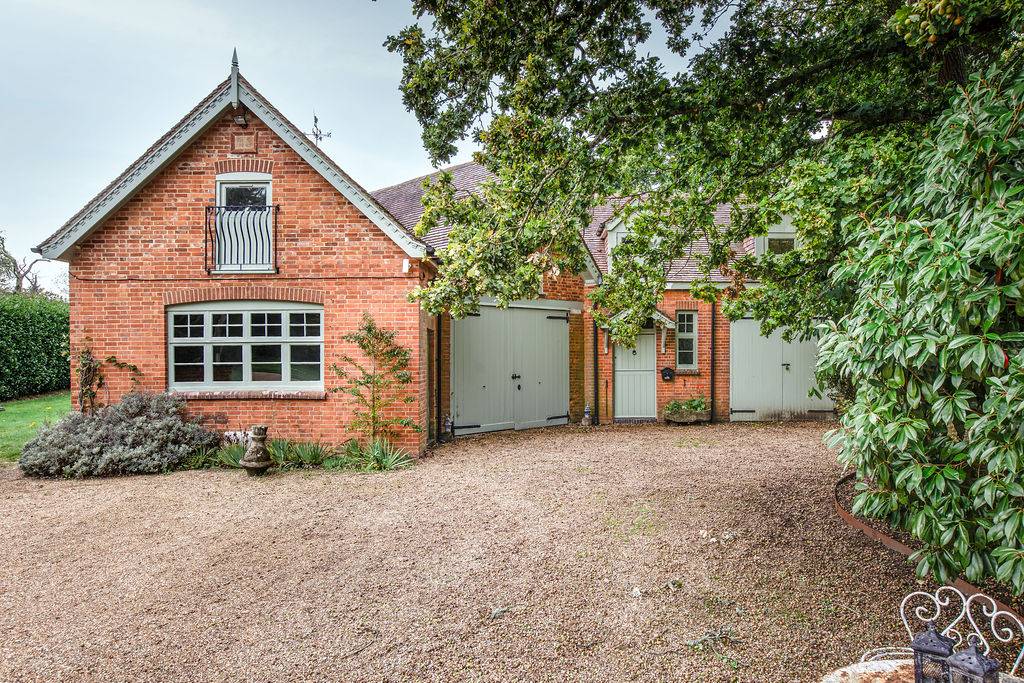 Traditional brick courtyard with garages and outbuildings at Love Locations property in Liss, Hampshire GU33.