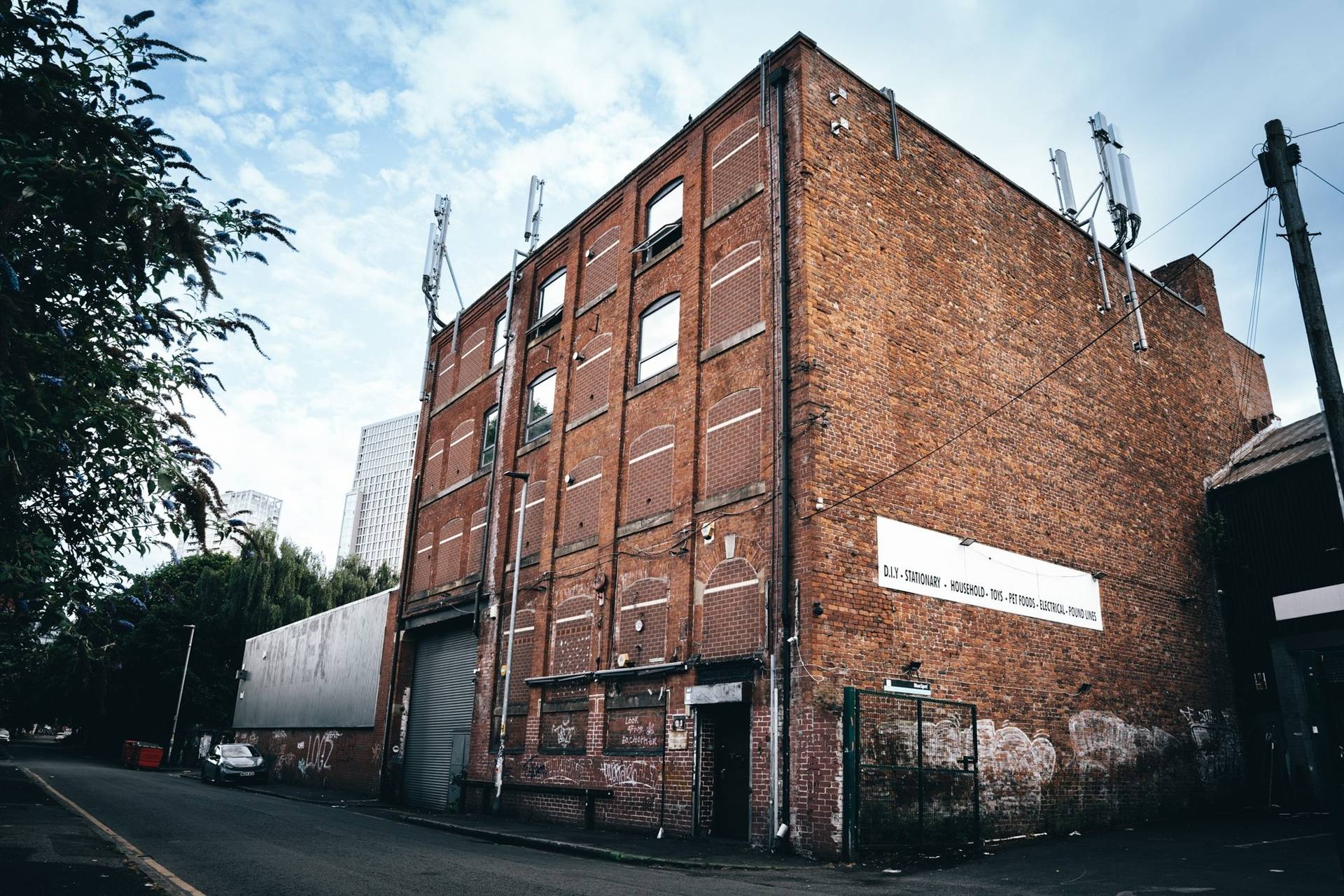 Exterior view of a multi-storey industrial red brick building and production venue in Cheetham Hill Manchester M3 available via Love Locations.
