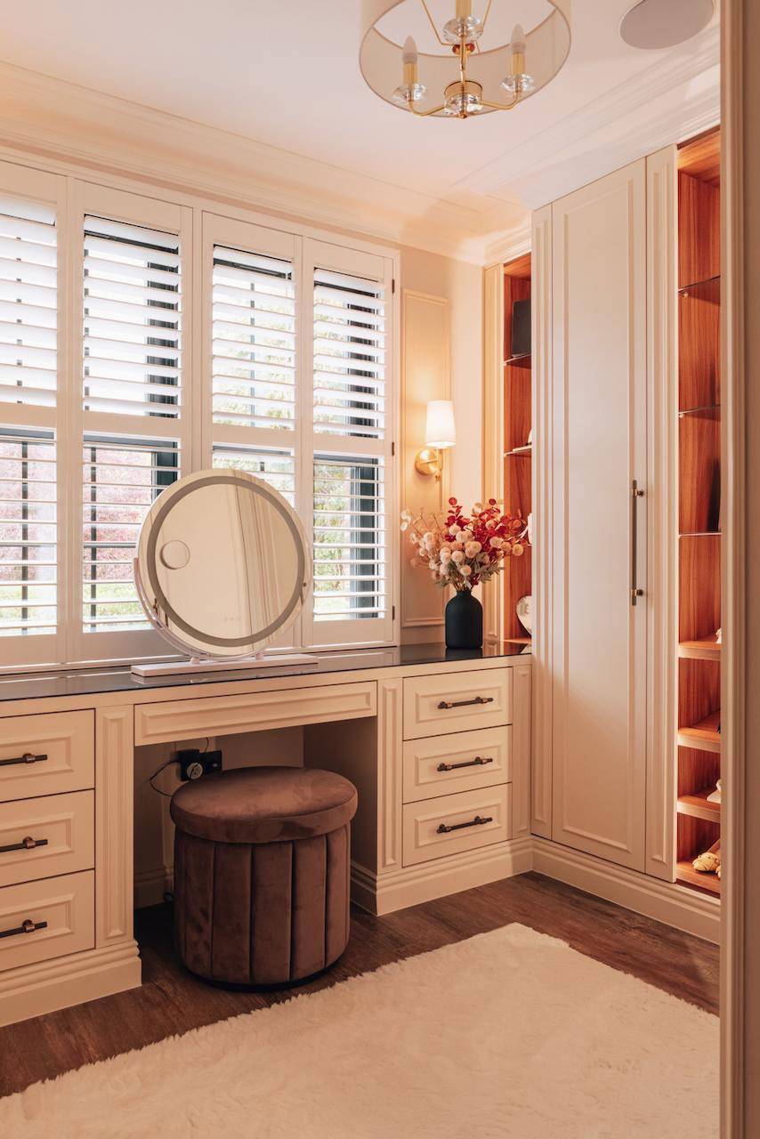 Custom dressing room vanity table with white window shutters, illuminated mirror, and oak wardrobes, perfect for beauty brand campaigns, Love Locations.