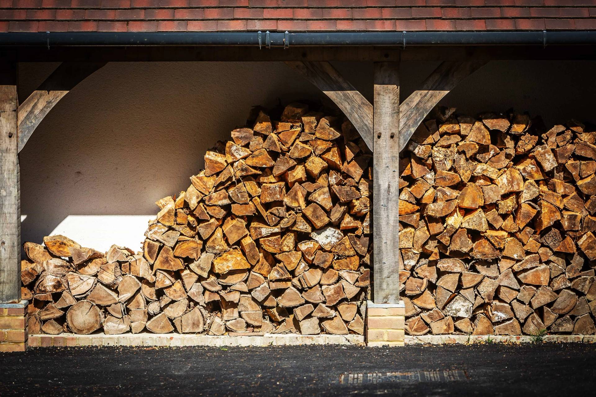 Grand country estate shoot location hero cover image in Surrey, GU27 featuring a stacked timber log store, expansive stone terraces, Italianate water gardens, home gym, and sweeping driveway, the ultimate high-visibility backdrop for automotive commercials, TV drama productions, and high-fashion brand campaigns via Love Locations.