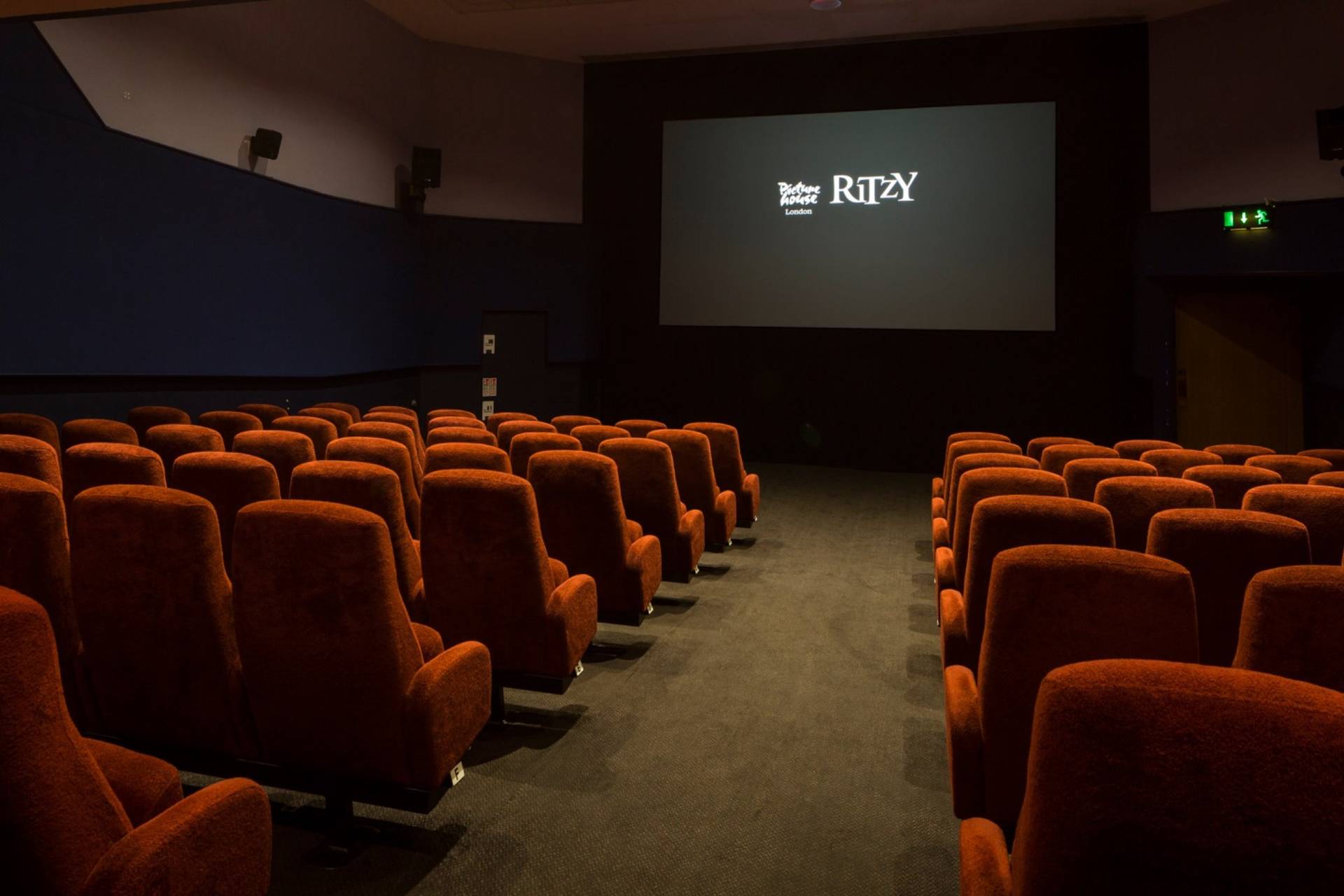Angled perspective looking down the aisle toward the cinema screen in The Ritzy Screen 3 venue hire in Brixton SW2 through Love Locations.