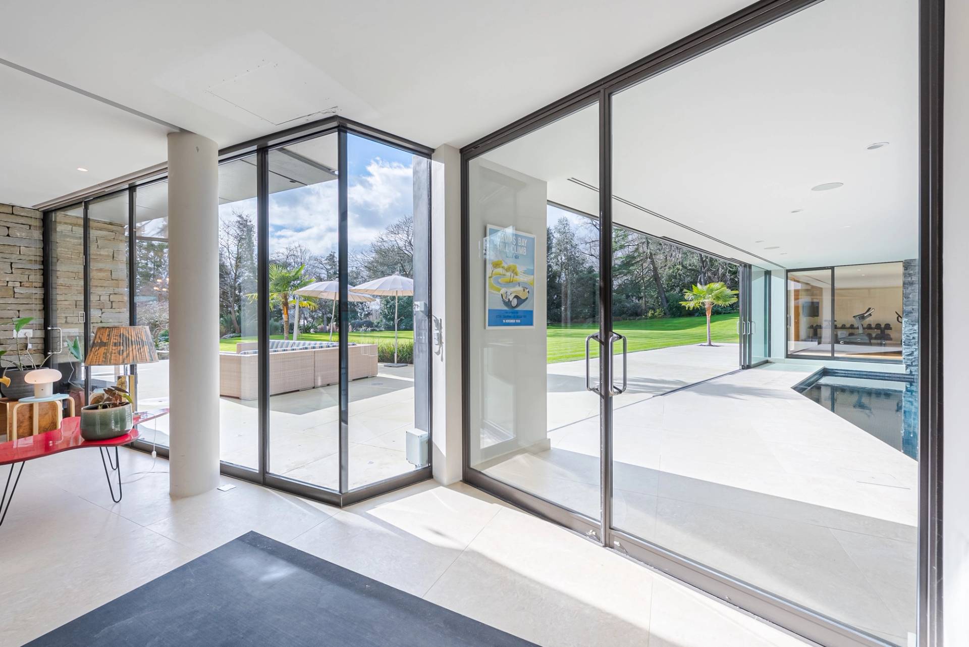 Bright corner glass transition hallway opening directly onto landscaped garden terraces, Love Locations KT2.