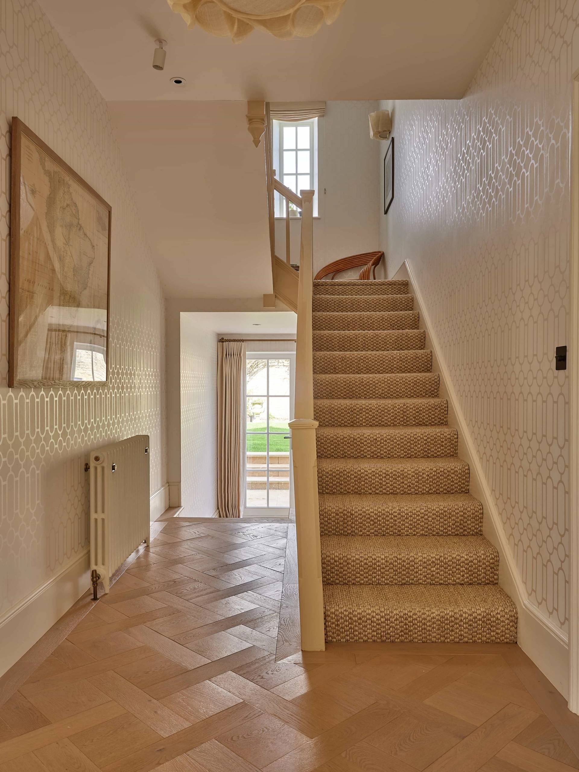 Stately entrance hallway showing herringbone parquet floorboards and a carpeted staircase in a Cotswolds estate, ideal for TV drama scenes, Love Locations.