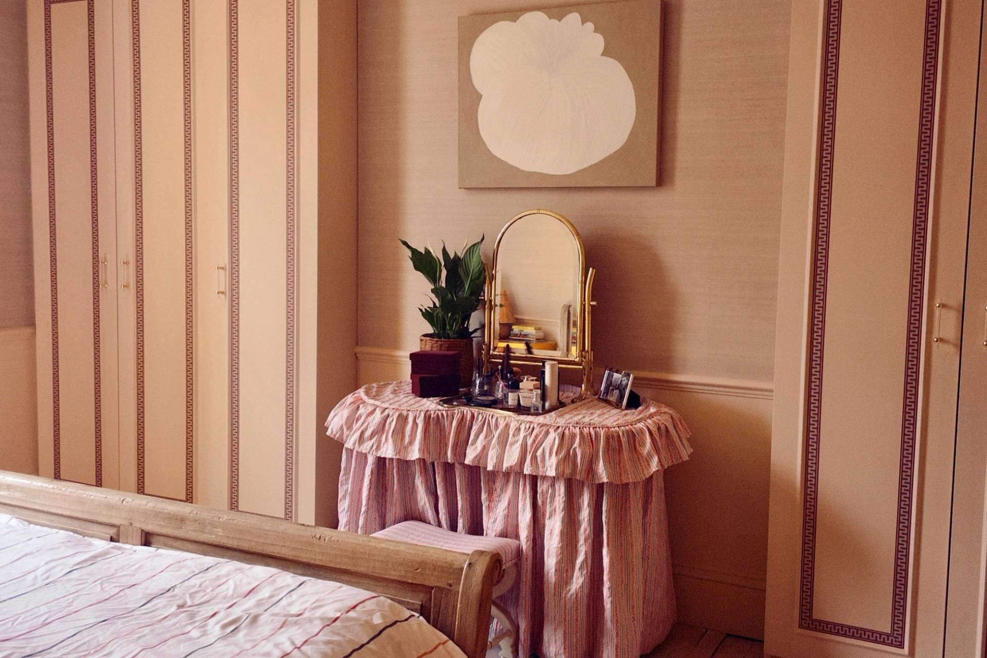 Vintage bedroom vanity setup draped in a pink ruffled tablecloth with a decorative oval mirror, ideal for beauty and cosmetic campaigns, Love Locations TW7.
