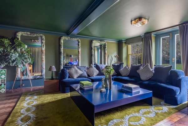 Expansive formal lounge film location in Liss Hampshire GU33 from Love Locations, spotlighting a large central cobalt blue coffee table and deep velvet seating.