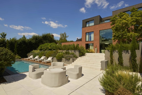 Luxury rear garden terrace featuring a swimming pool and high-end outdoor furniture in Chislehurst, Love Locations.