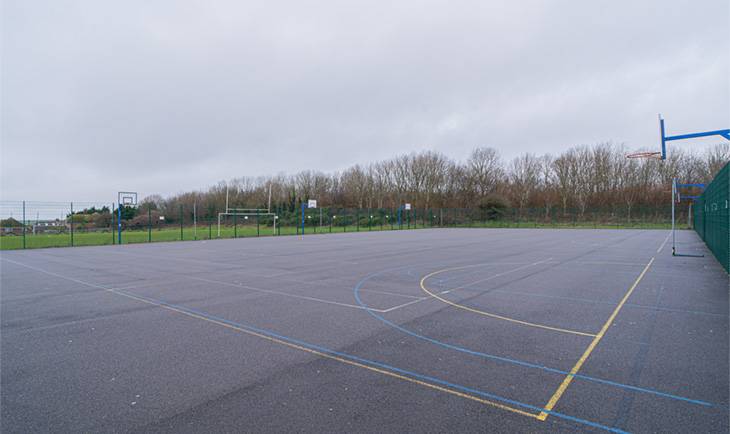 Outdoor tarmac school playground and sports court location in Hove BN3 with netball court lines by Love Locations.