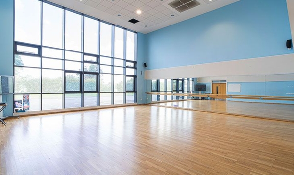 Love Locations dance studio shoot location South East London SE2: Professional rehearsal space with a full-length wall mirror and ballet barre on light wood floors, ideal for music videos and fitness ads.