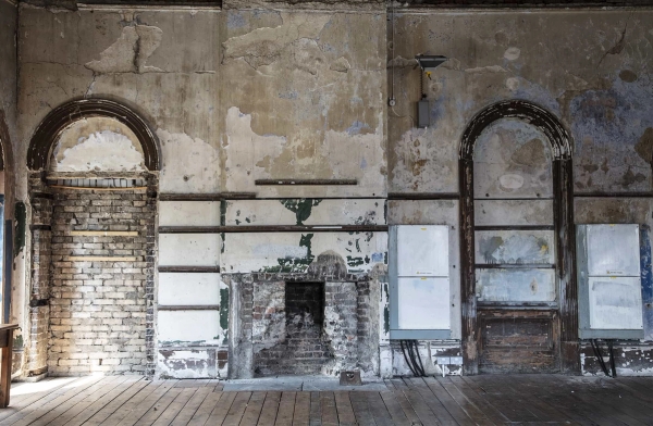 Moody, light-filled former billiards hall with cracked plaster and original station windows—an atmospheric Peckham venue for creative photography and immersive art events.