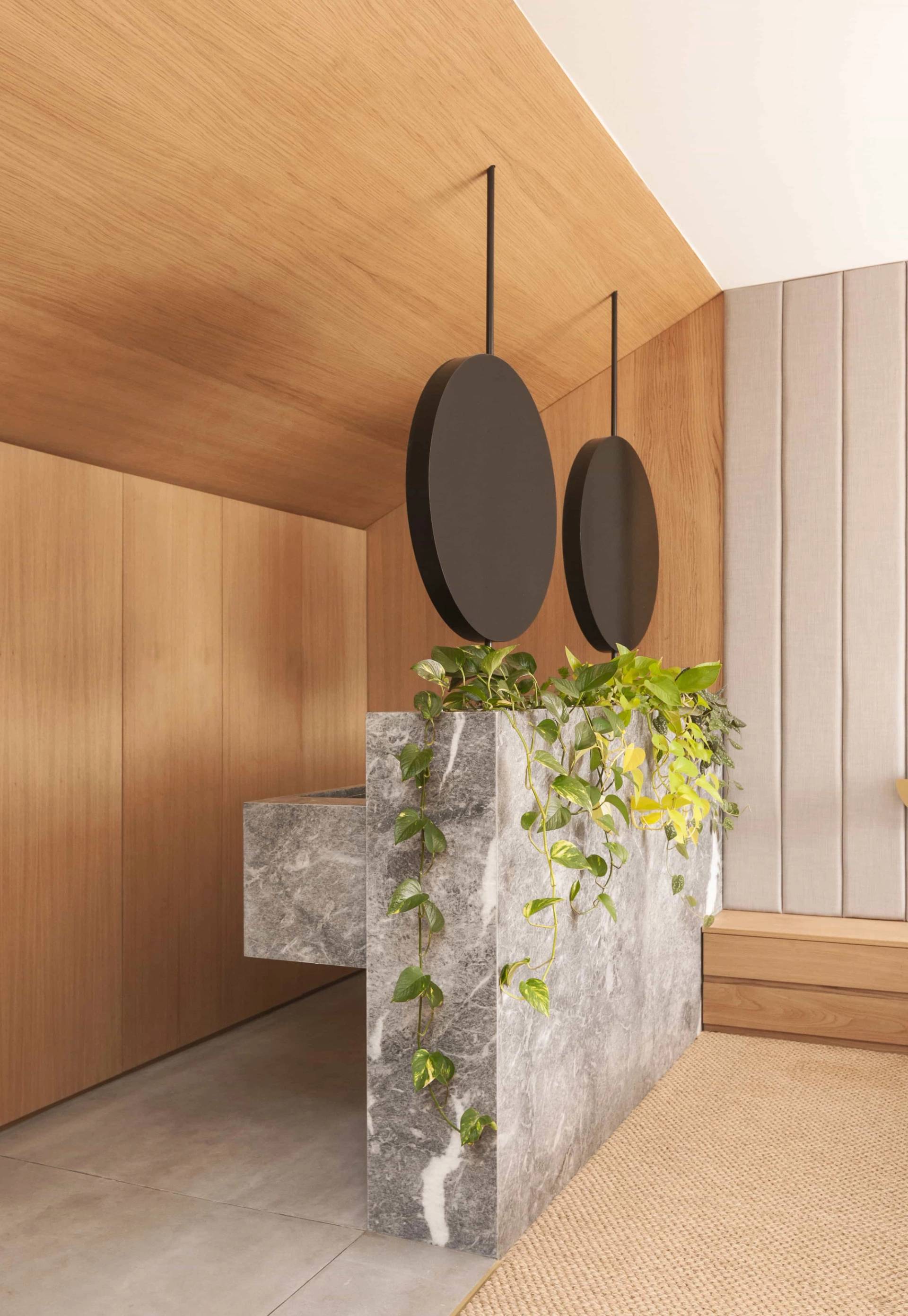 Detail of terrazzo vanity island with double sinks and indoor potted plants in a modern Hackney N16 location home through Love Locations.
