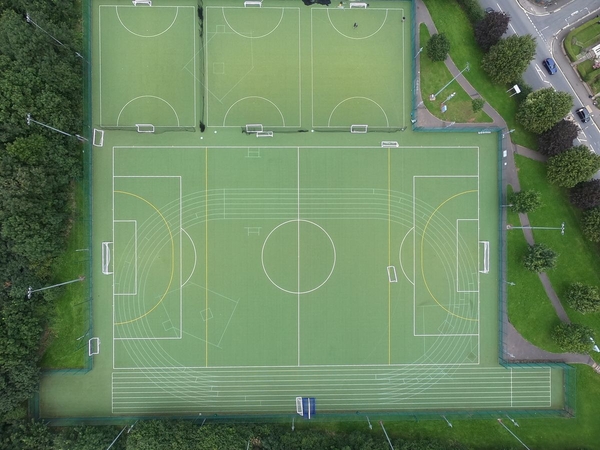 Love Locations birds eye view production space BS7: Perfect top-down aerial photograph mapping out multiple green sports fields and white tactical boundary lines, optimized for athletic brand campaigns.