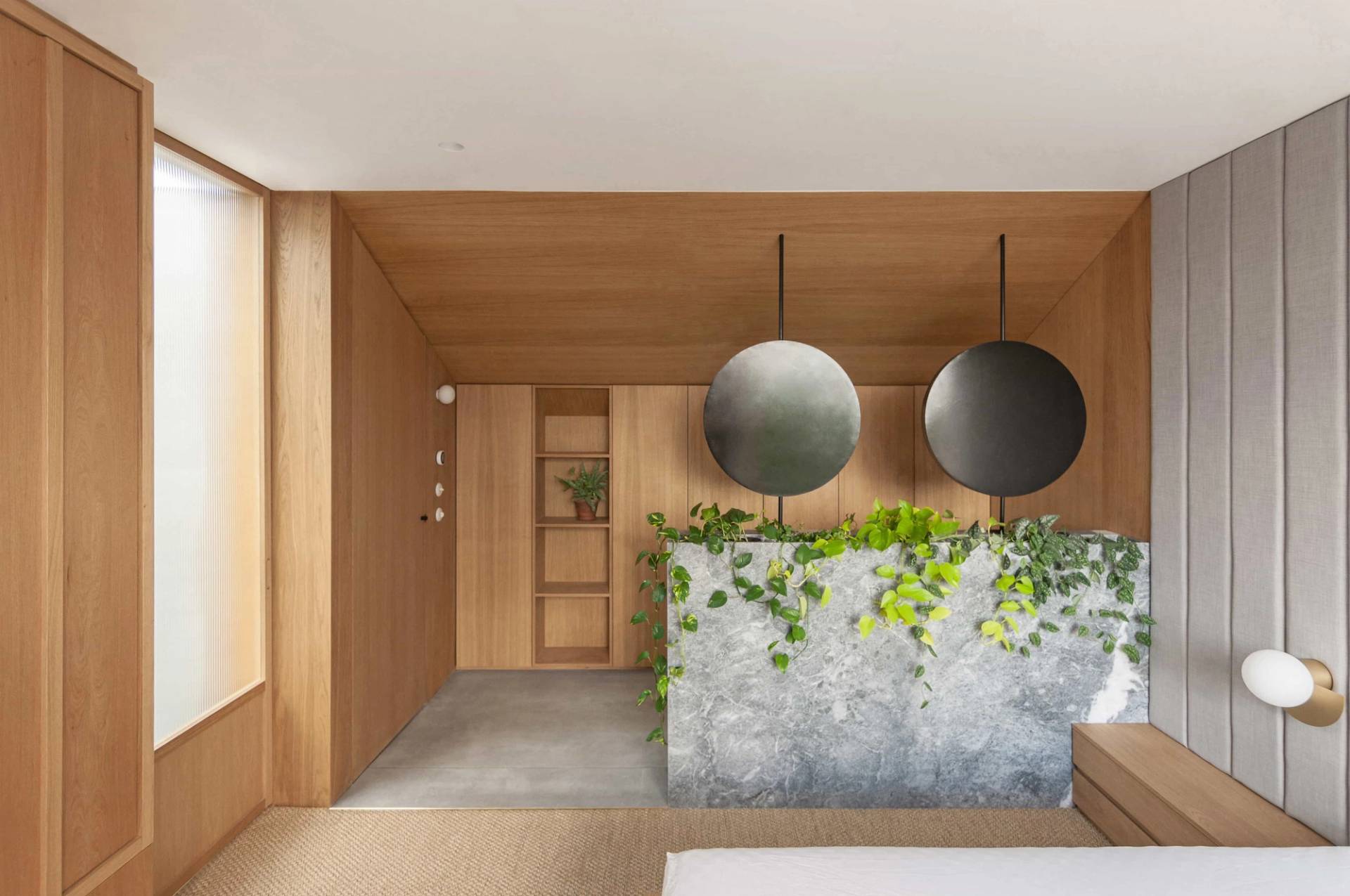 Editorial master bathroom shoot location in Hackney N16 via Love Locations, featuring a custom grey terrazzo double vanity island and dual round hanging mirrors.