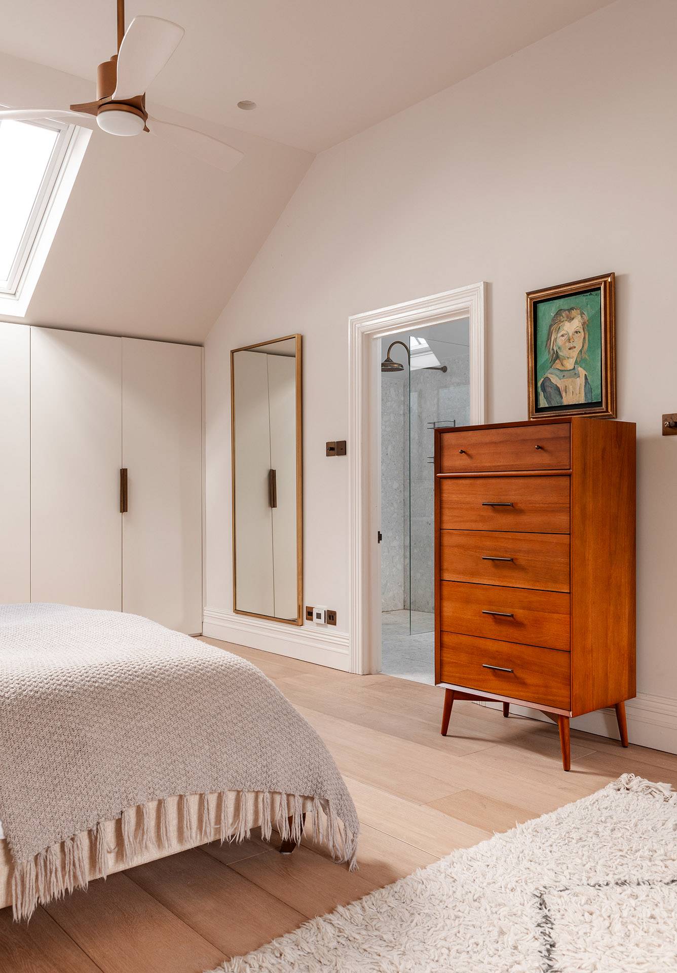 Master bedroom corner displaying a rich timber chest of drawers and framed artwork, ideal for upscale furniture ads, Love Locations TW1.