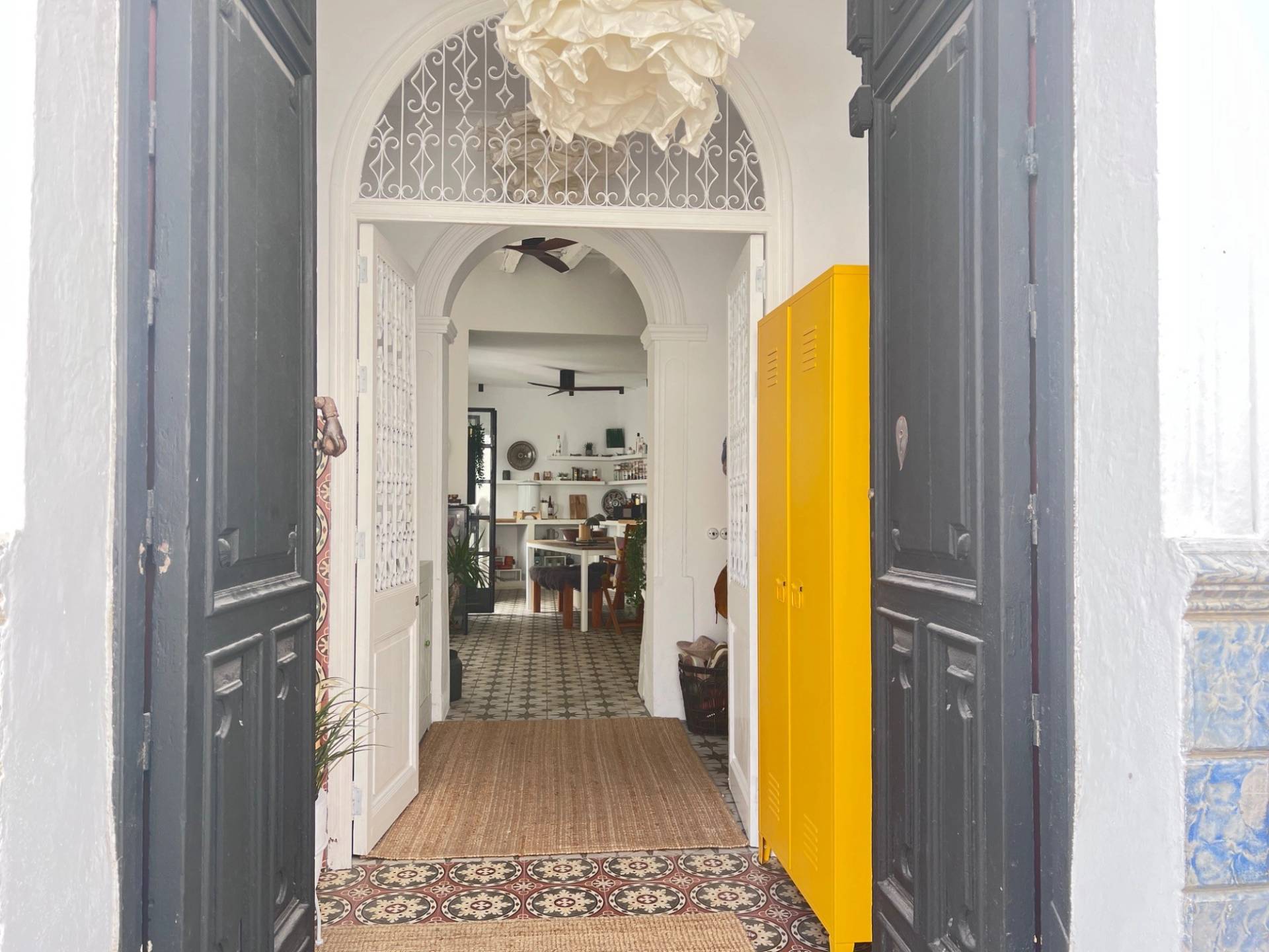 Grand entrance hallway and foyer in Calle Sevilla Jimena de la Frontera Cádiz from Love Locations, featuring dark wooden double front doors and an eye-catching yellow cabinet.