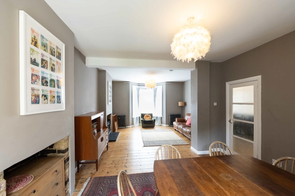Love Locations sprawling double reception room Forest Gate: Long perspective look from the dining table through to the front bay window lounge, providing exceptional depth of field for cinematic filmmaking.