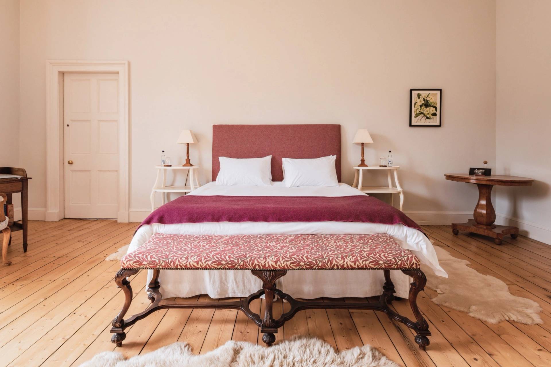 Elegant bedroom suite featuring a red throw bench, white linens, and high ceilings, Love Locations KY15.