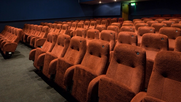 Detailed view across multiple rows of plush red velvet theater chairs inside The Ritzy Screen 3 production space, curated by Love Locations.