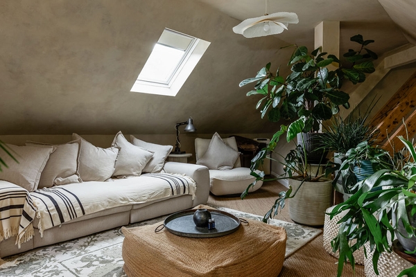 Relaxed attic sitting room with rooflight, soft furnishings and plants at Love Locations in Liss, Hampshire GU33.