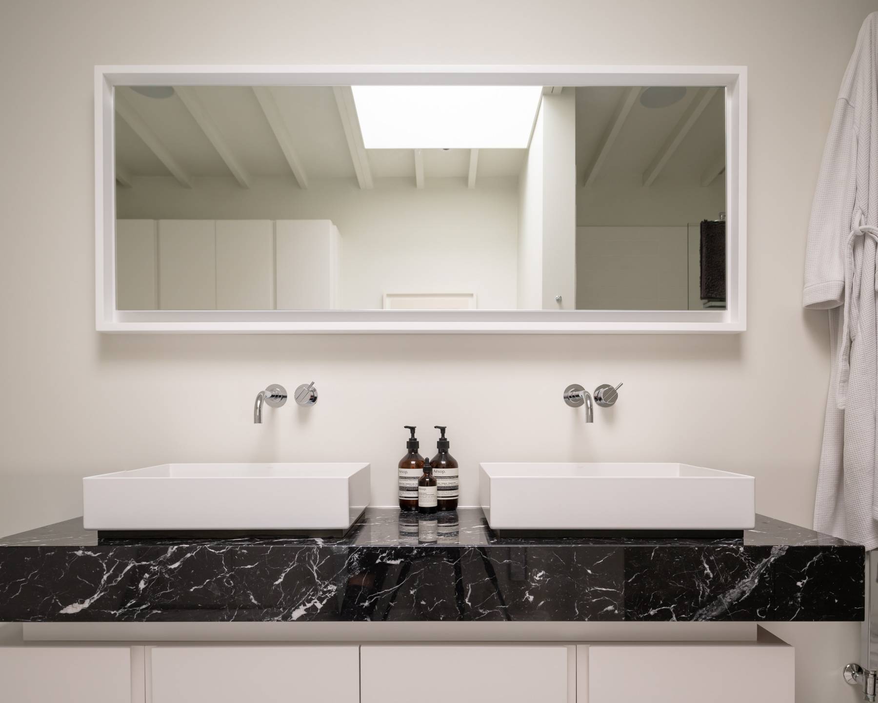 Double sink bathroom vanity unit with black marble countertops, twin rectangular sinks, and large mirror, Love Locations BN3.
