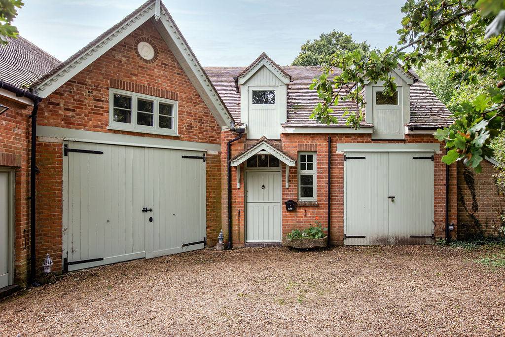 Character brick house with gravel driveway and period architecture at Love Locations in Liss, Hampshire GU33.