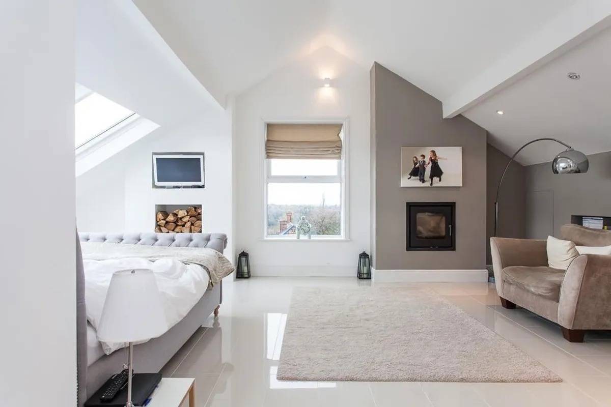 Bright contemporary bedroom shoot location in Stockport SK6 from Love Locations, showcasing sloped ceiling skylights and polished floor tiles.