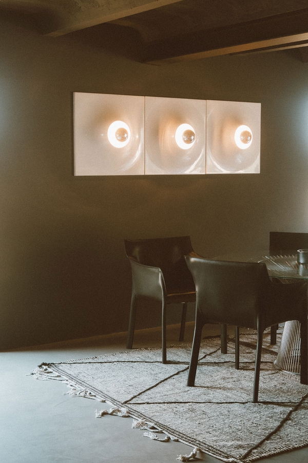 Modern dining area with round glass wall sconces and dark wooden dining furniture, Love Locations 07630.