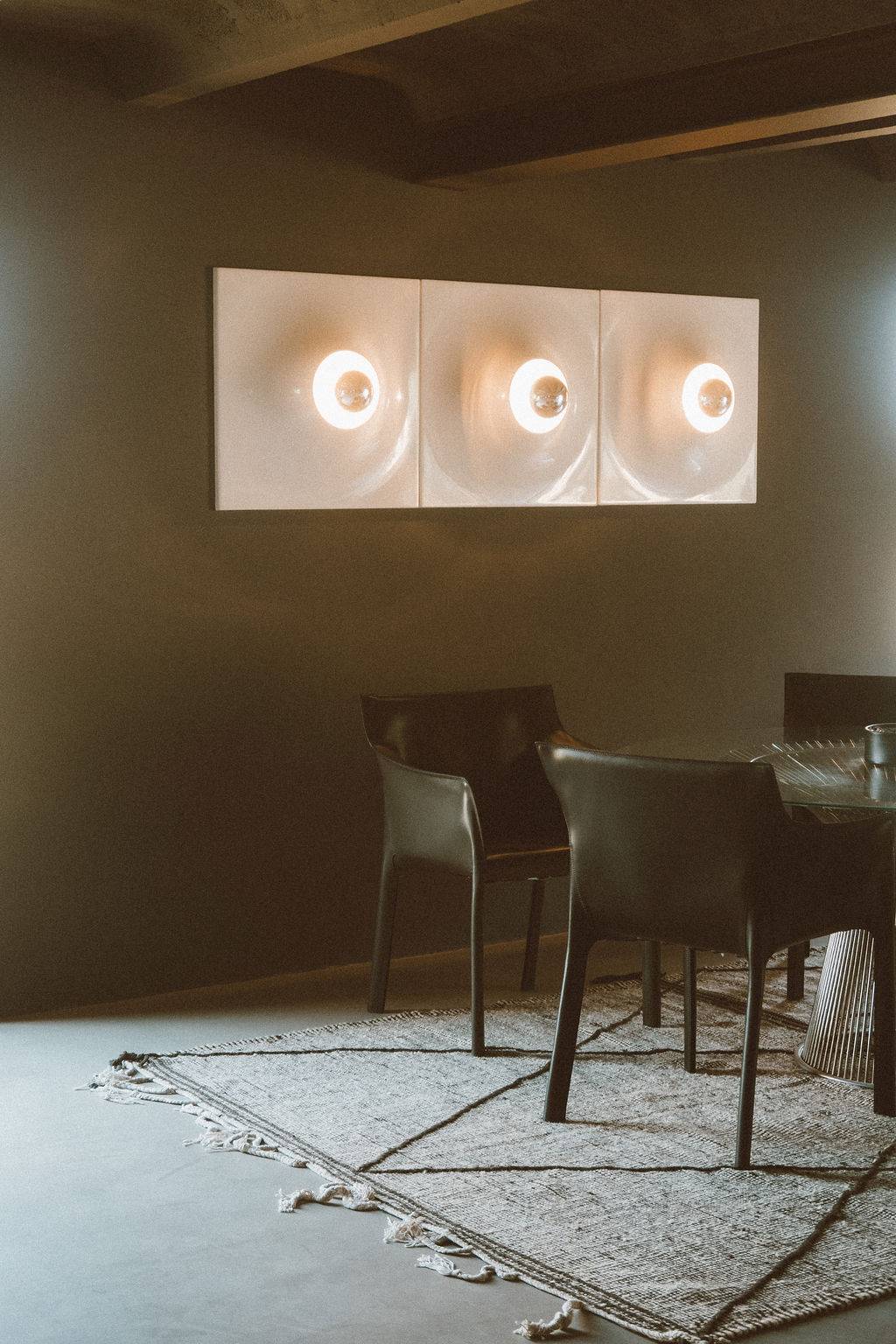 Modern dining area with round glass wall sconces and dark wooden dining furniture, Love Locations 07630.