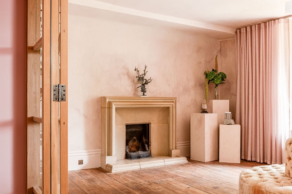 Minimalist stone-carved fireplace mantle in a spacious, un-dressed neutral reception room, a versatile lookbook location by Love Locations.