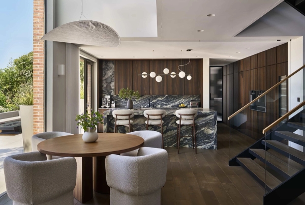 Contemporary luxury kitchen with dark wood cabinetry and a dramatic green marble island for film shoots in Chislehurst, BR7 via Love Locations.