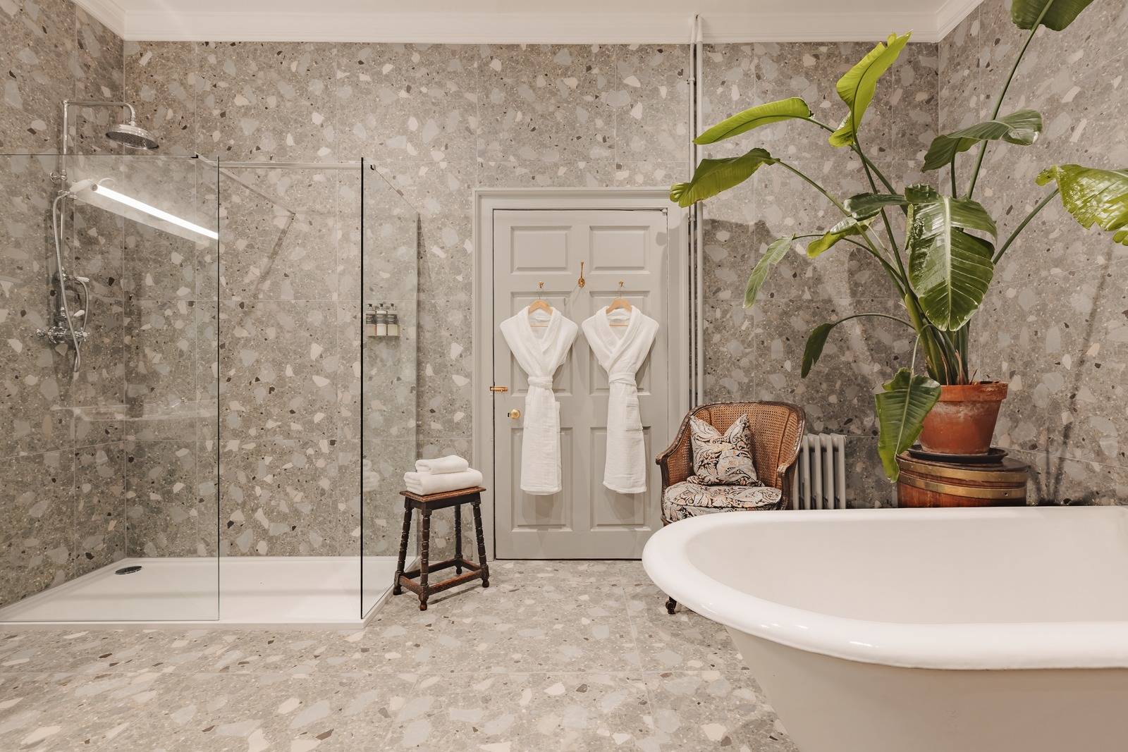 En-suite bathroom with glass walk-in shower, freestanding bathtub, and floral wallpaper, Love Locations KY15.