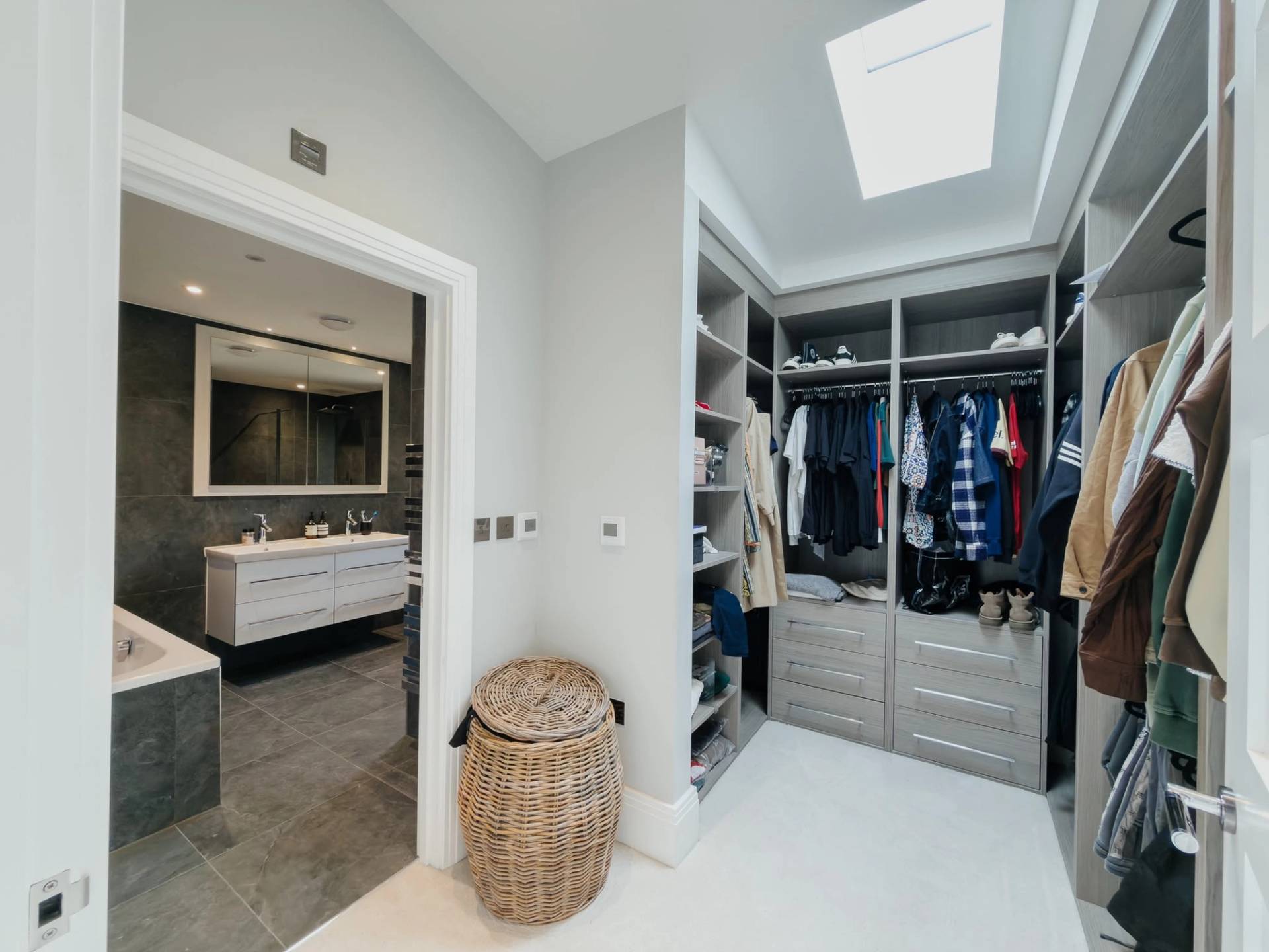 Luxury walk-in wardrobe and dressing room film location in Barnet EN4 from Love Locations, featuring bespoke open shelving and a skylight window.