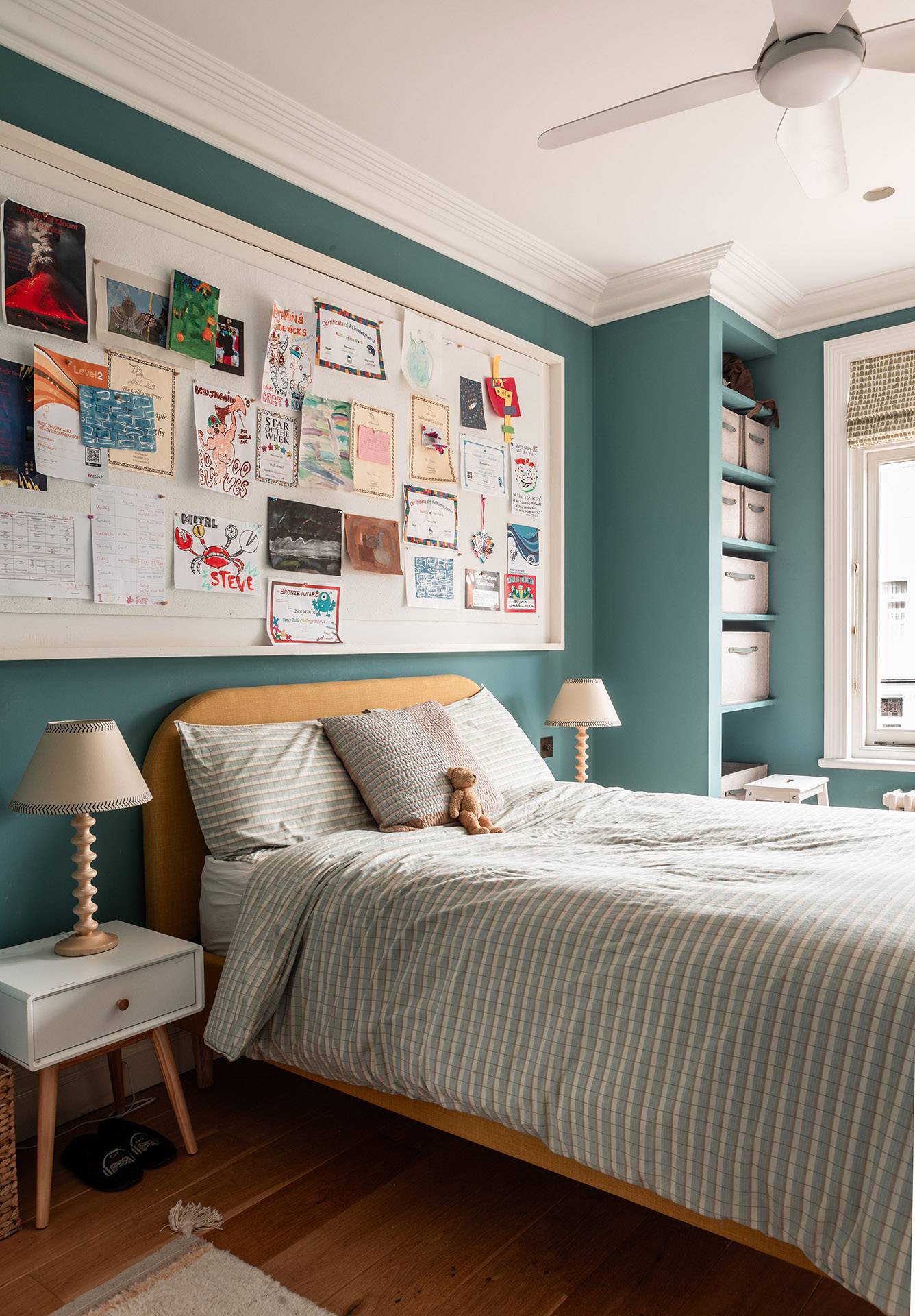 Teal blue bedroom setup featuring a pinboard feature wall and mid-century wooden bedside tables, perfect for teen lifestyle shoots, Love Locations.