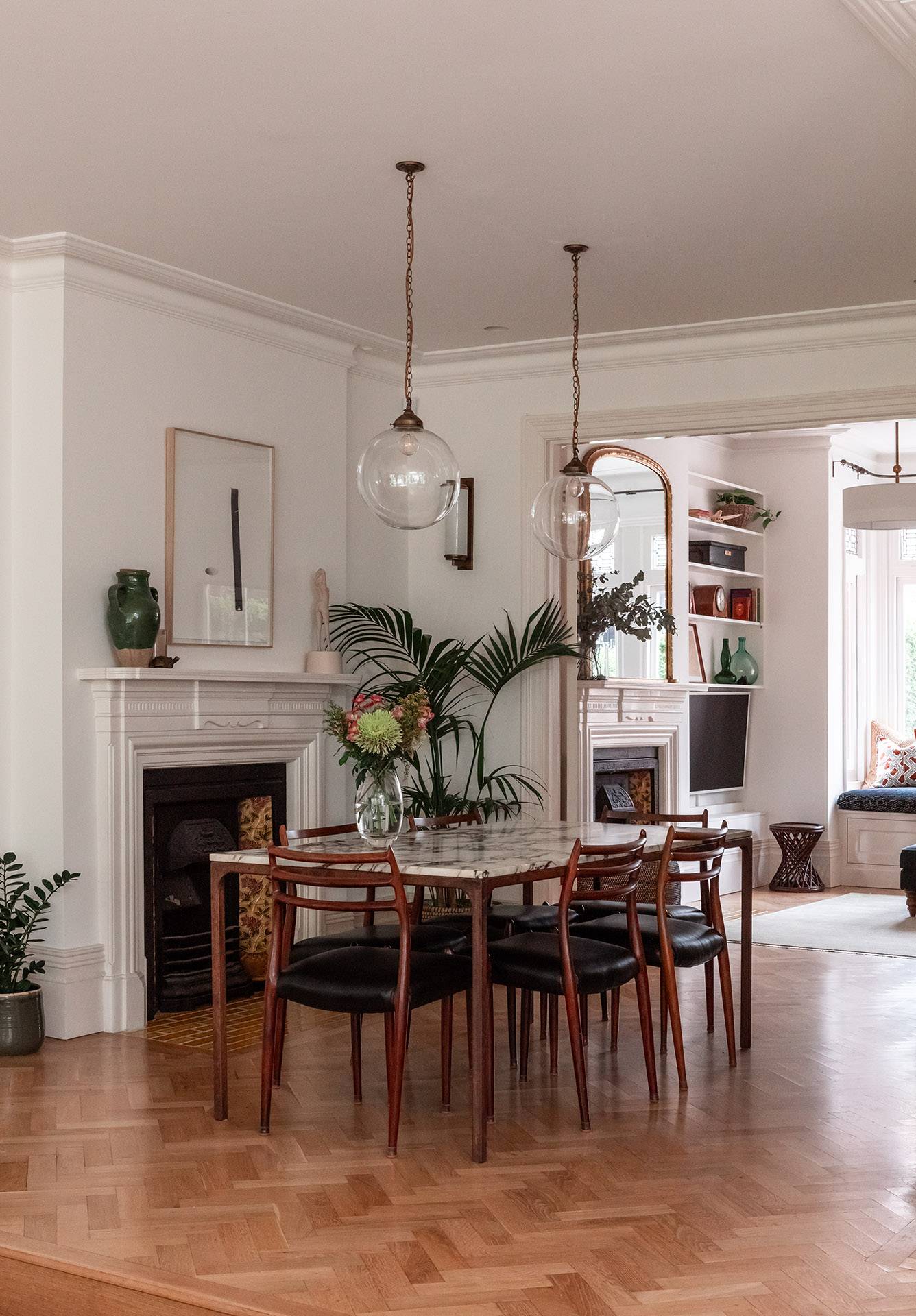Formal dining area featuring a classic fireplace, glass pendant light, and large wall mirror, ideal for period drama scenes, Love Locations TW1.