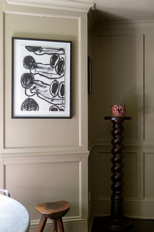 Grey panelled wall detail featuring abstract black-and-white framed poster art, Love Locations ME13.
