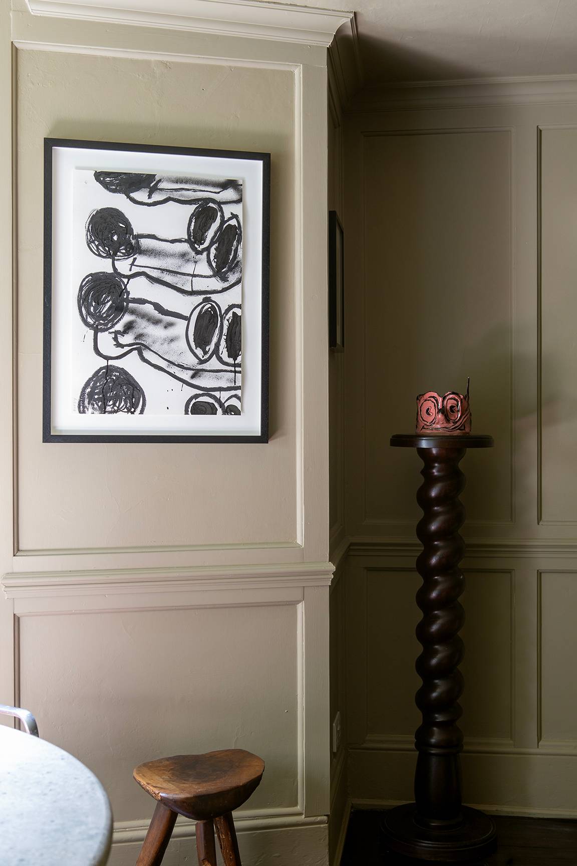 Grey panelled wall detail featuring abstract black-and-white framed poster art, Love Locations ME13.