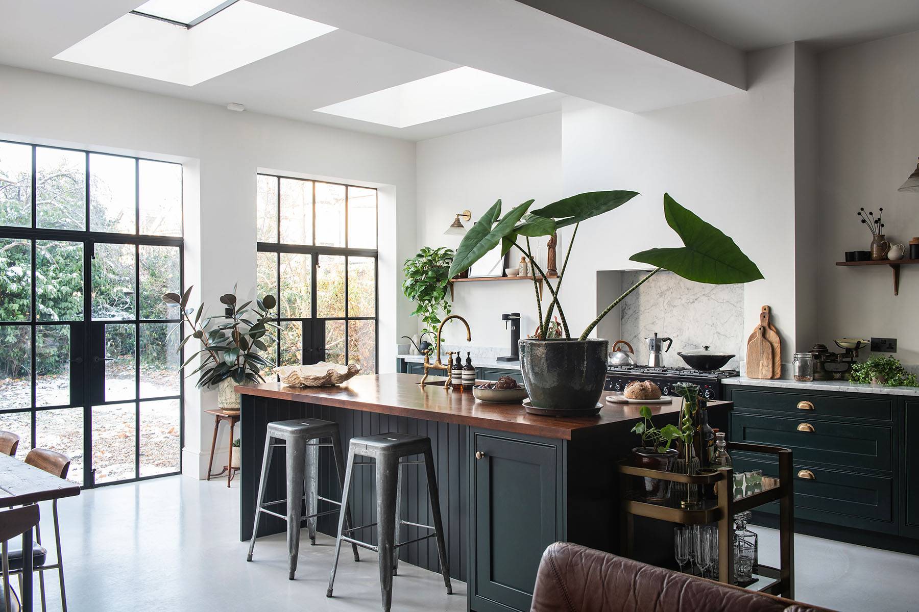 Spacious kitchen location with dark green island, butcher block worktop, skylights, and Crittall double doors in Streatham, Love Locations SW16.