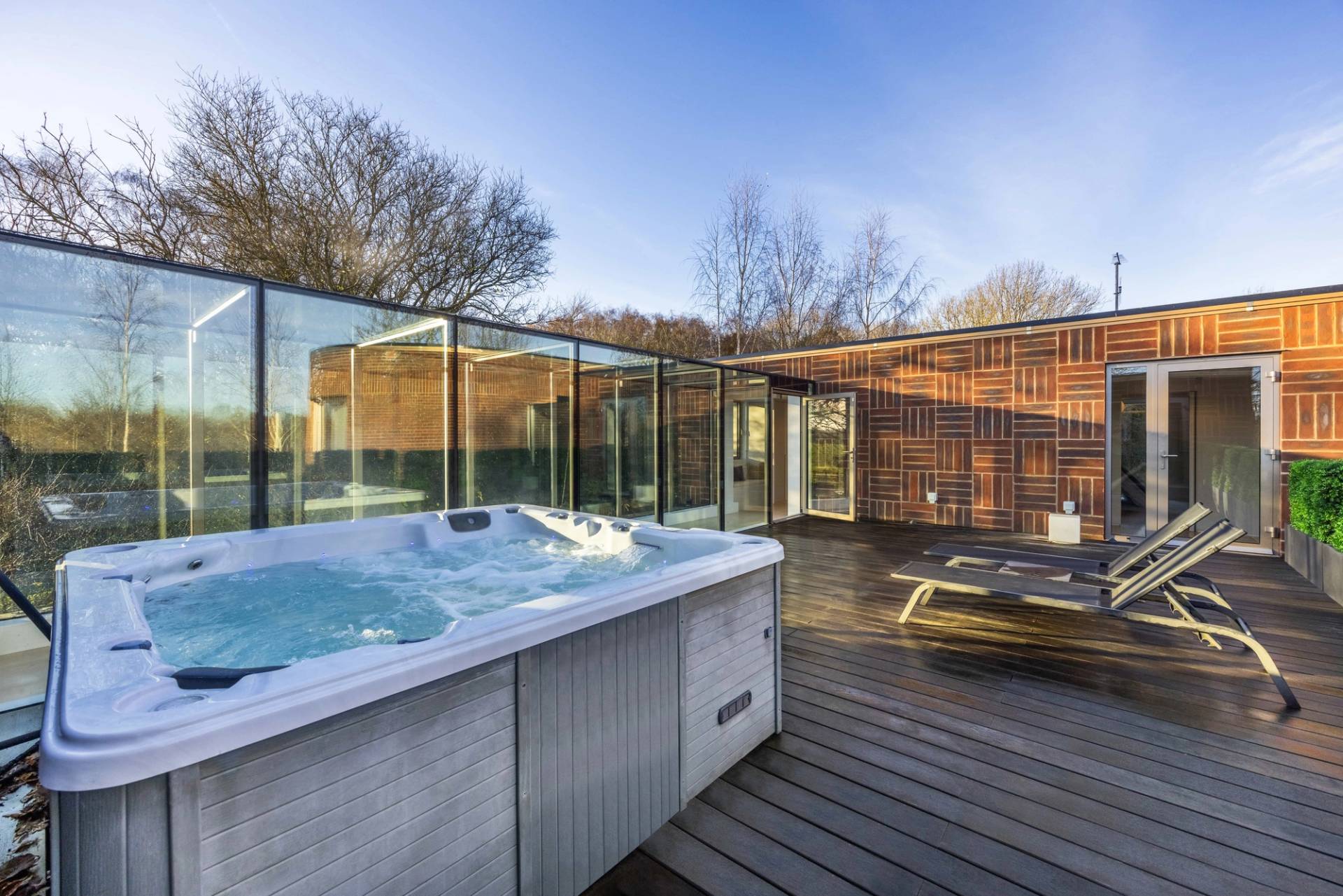 Rooftop terrace lounge in Radlett, WD7 featuring a sunken outdoor hot tub jacuzzi and timber decking, Love Locations.