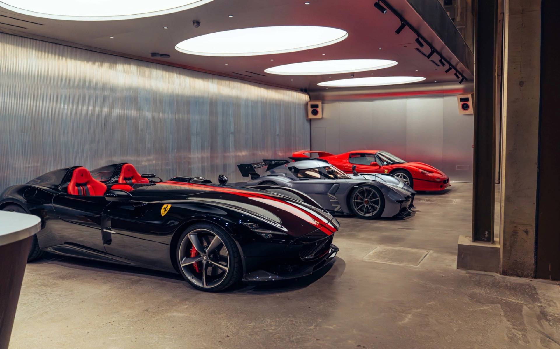Modern industrial showroom and listening bar featuring luxury sports cars in Brentford TW8 by Love Locations.