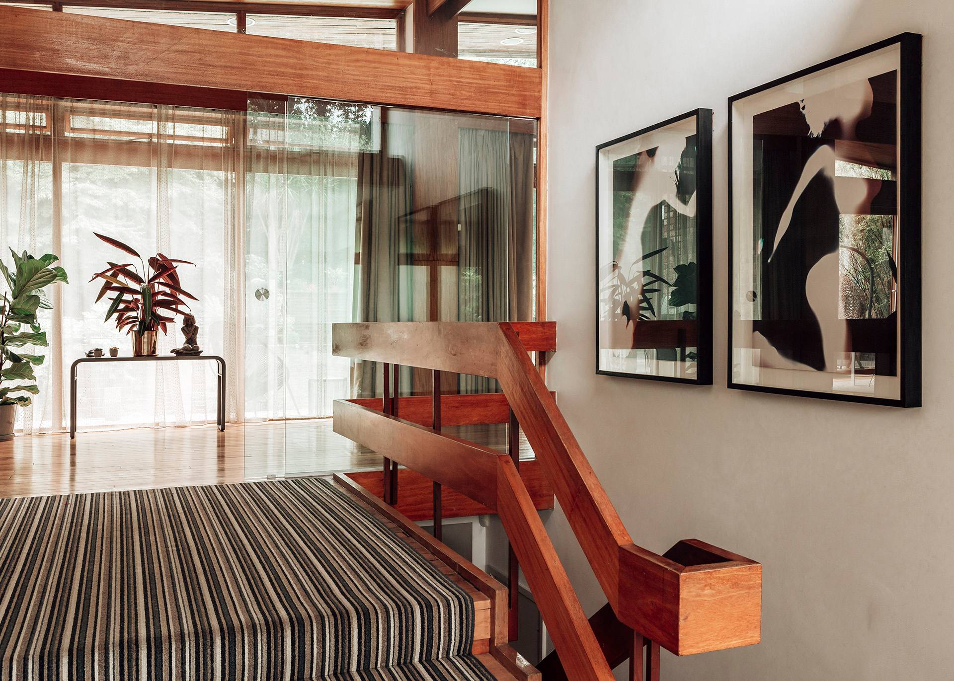 Mid-century open staircase detail with clean wooden railings and glass divider partitions overlooking the lower level, Love Locations Bromley.