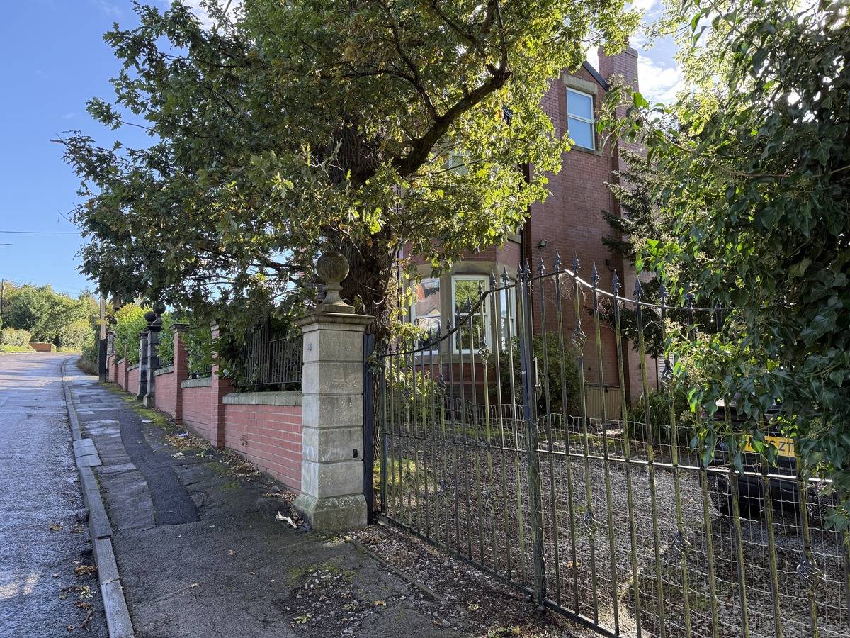 Front gated entrance and stone driveway leading up to a period family location house in Stockport SK6 by Love Locations.