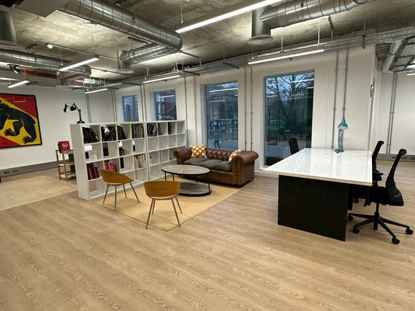 Bright shoot location with open shelving, desk area, breakout sofa, and colourful wall art – ideal for lifestyle or workspace shoots.