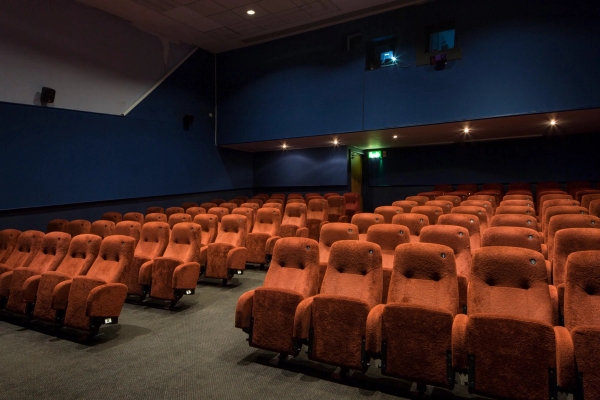 Wide angled shot of the red velvet cinema seating and dark blue interior walls at The Ritzy Screen 3 shoot location in Brixton SW2 via Love Locations.