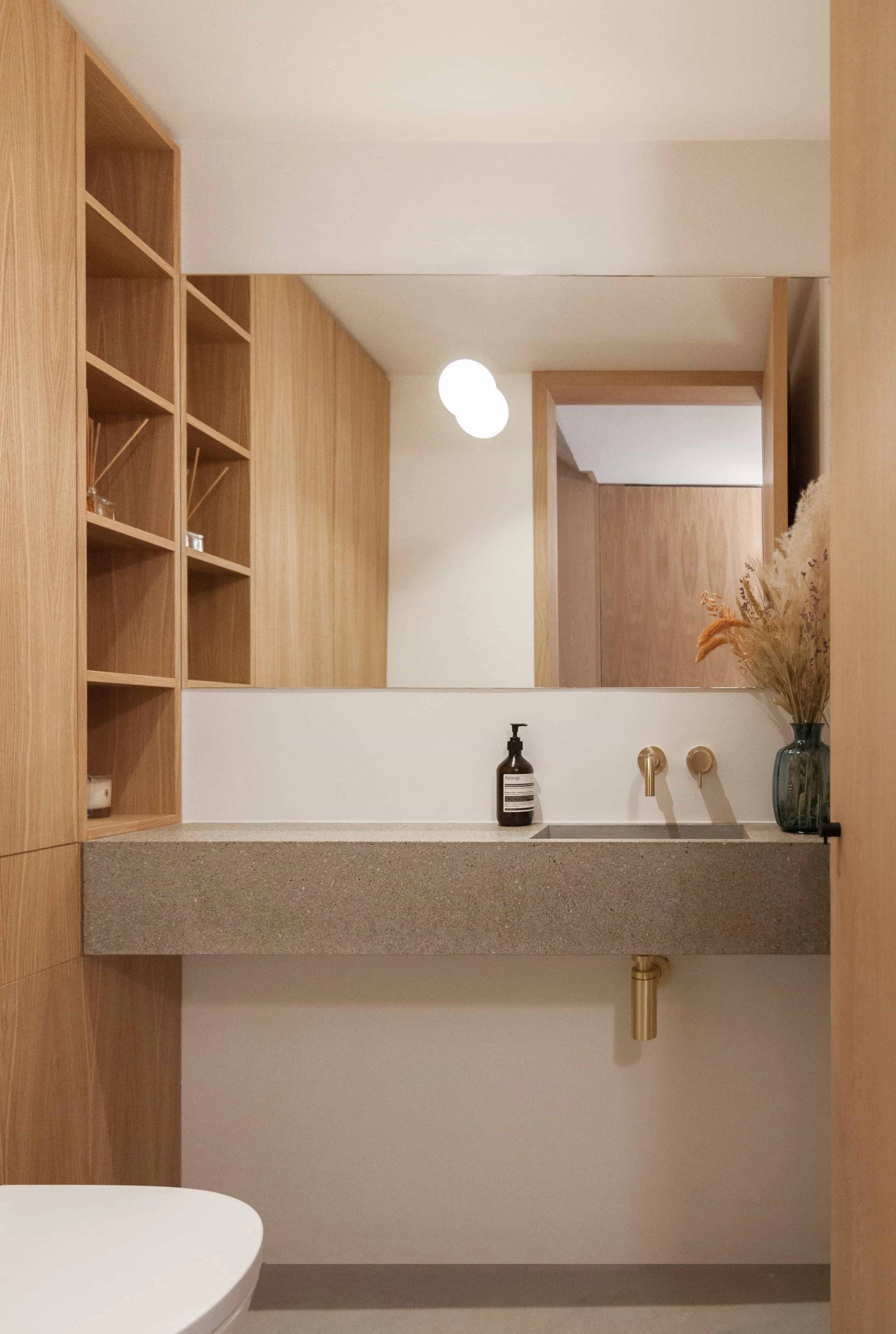 Modern concrete and light wood vanity sink in a luxury bathroom location house in Hackney London N16 through Love Locations.