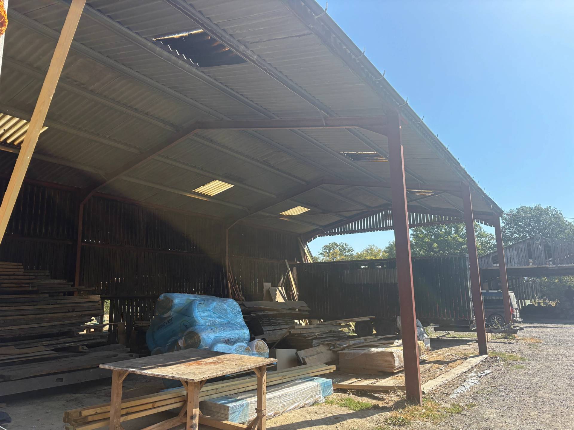 Interior perspective of a covered steel-frame farm Dutch barn used for storage and filming space, Love Locations BN8.
