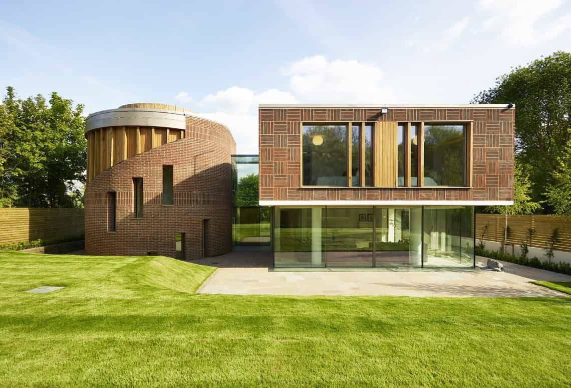 Architectural exterior view of a contemporary red brick and glass villa in a gated Radlett development, Love Locations WD7.