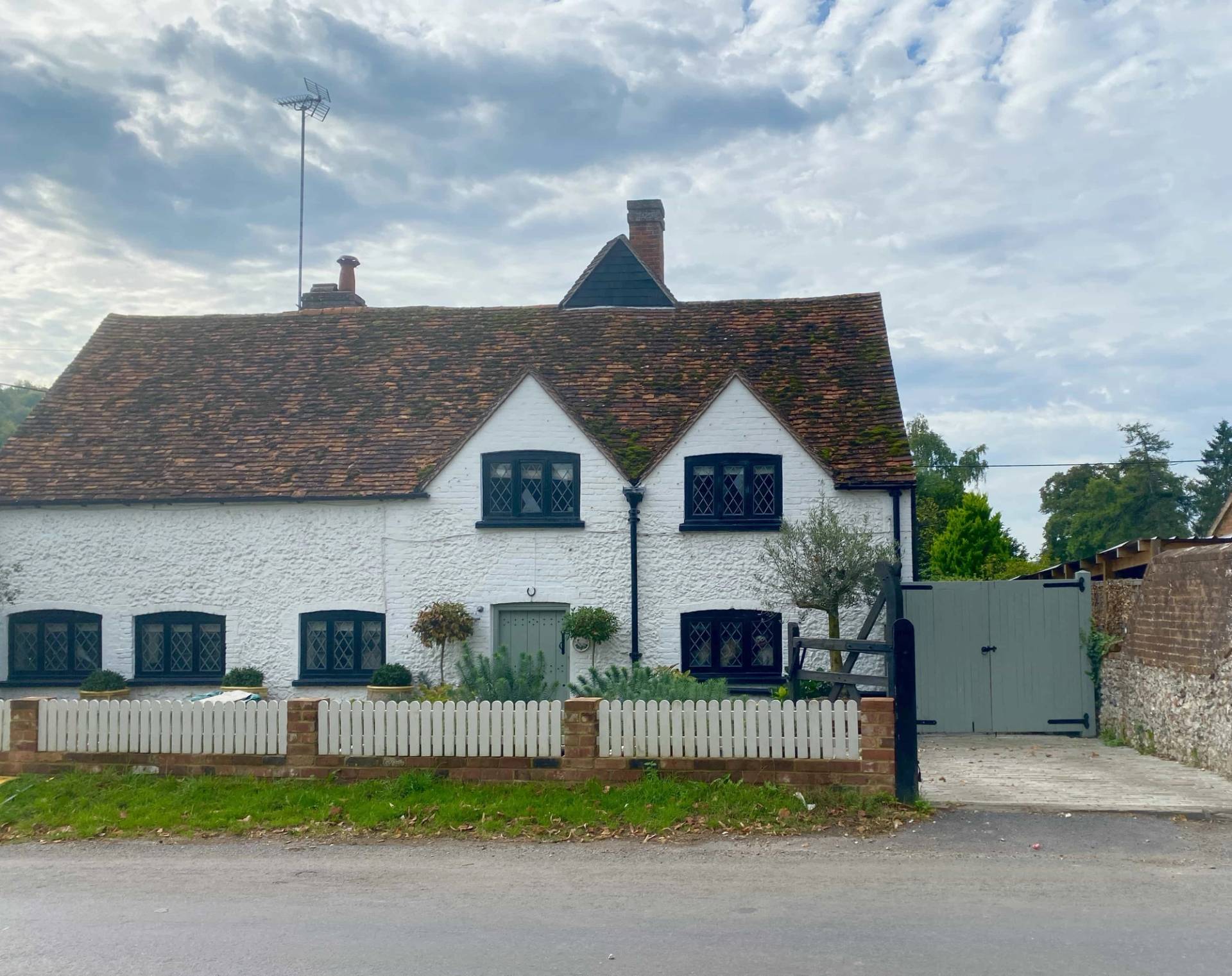 Front street view of a picturesque Tudor cottage location nestled in a tranquil woodland valley setting in RG9 6QD, Love Locations.