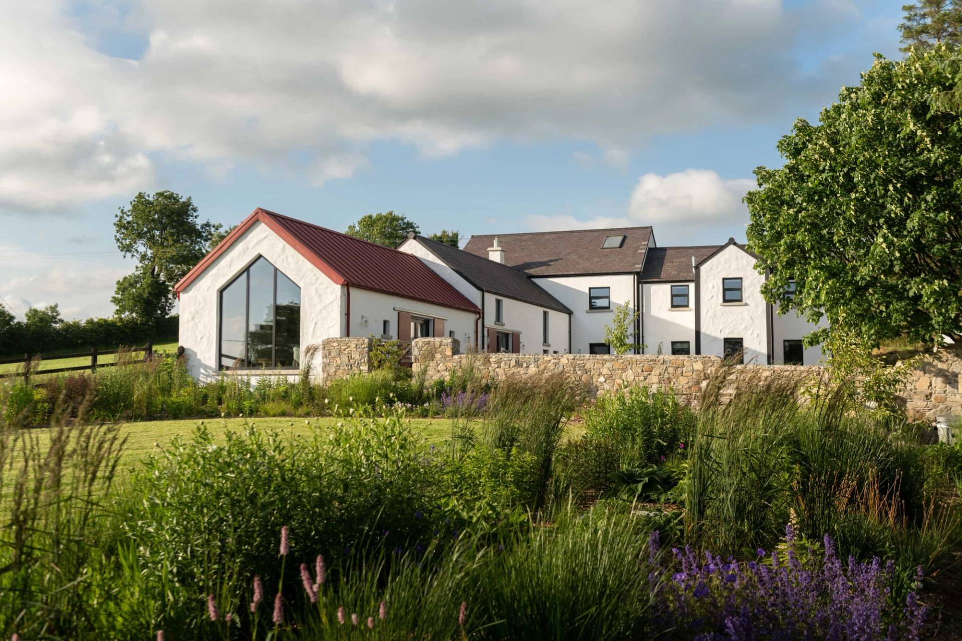 Landscaped stone patio and courtyard garden view of a renovated farmhouse in Castleblayney County Monaghan Ireland by Love Locations.